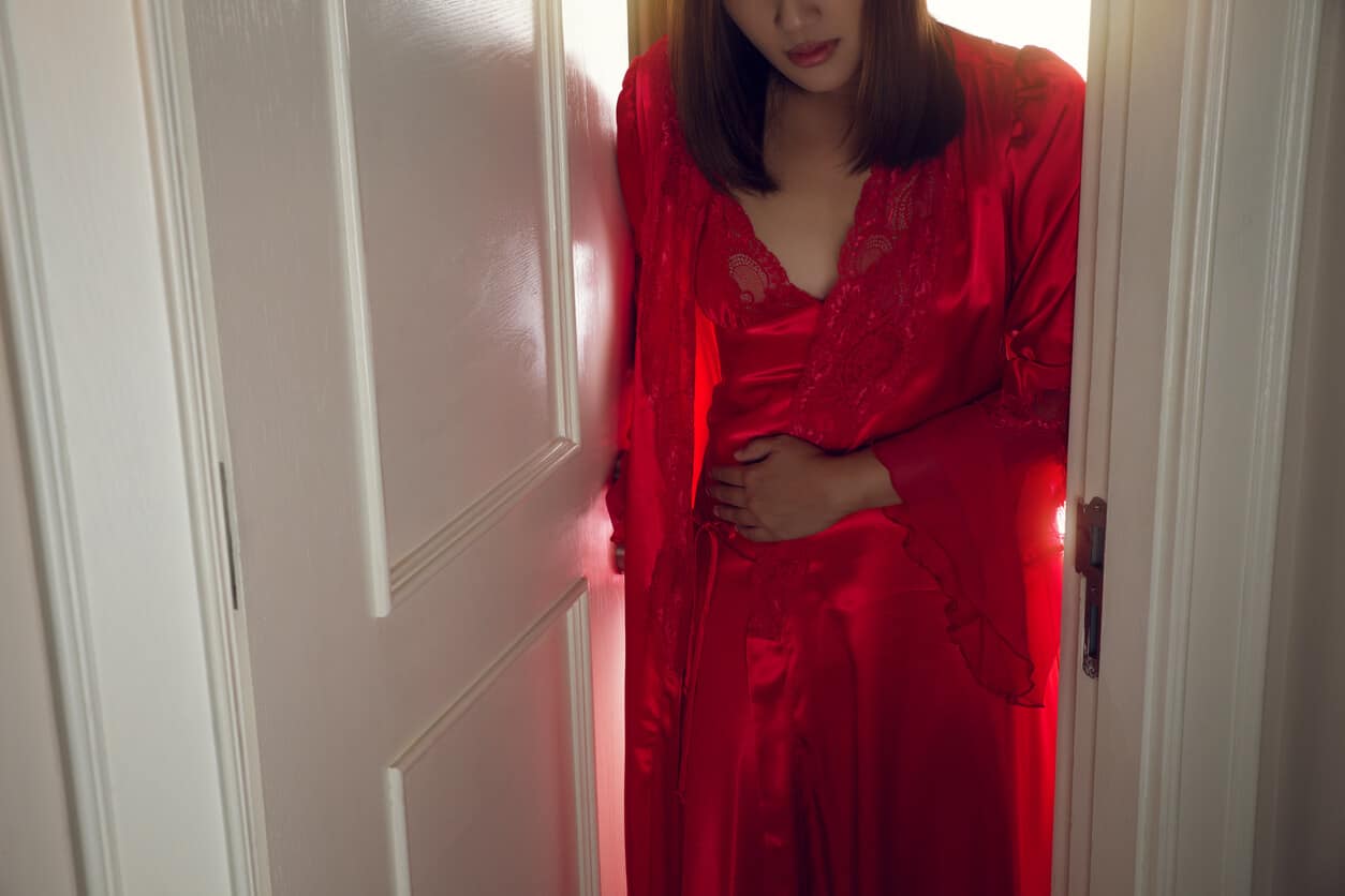 The Woman in Red Nightgown Wearing a Silk Robe Wakes up to Go to the Restroom. 
