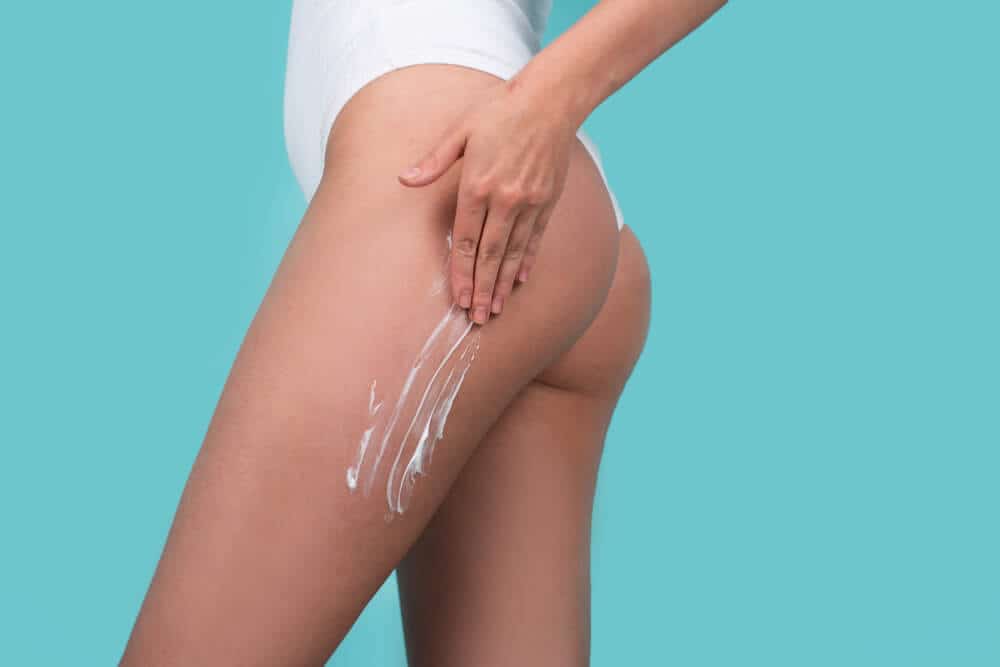 Cosmetic Cream on Woman Buttocks With Clean Soft Skin. Applying Moisturizer Cream