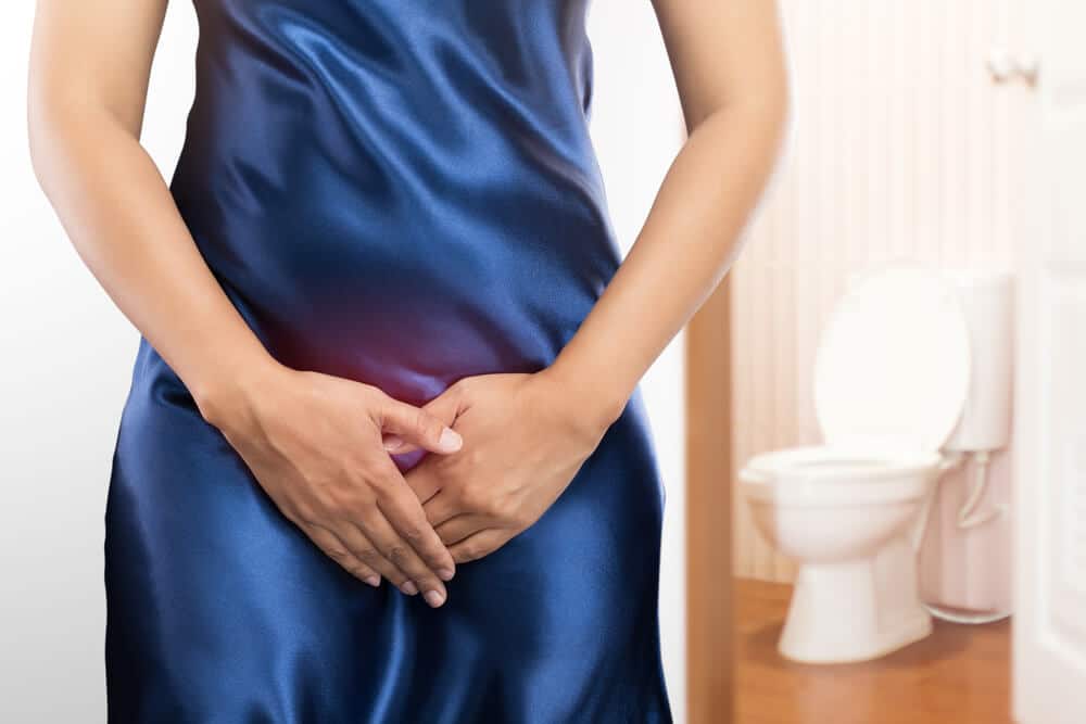 Woman With Prostate Problem in Front of Toilet Bowl.